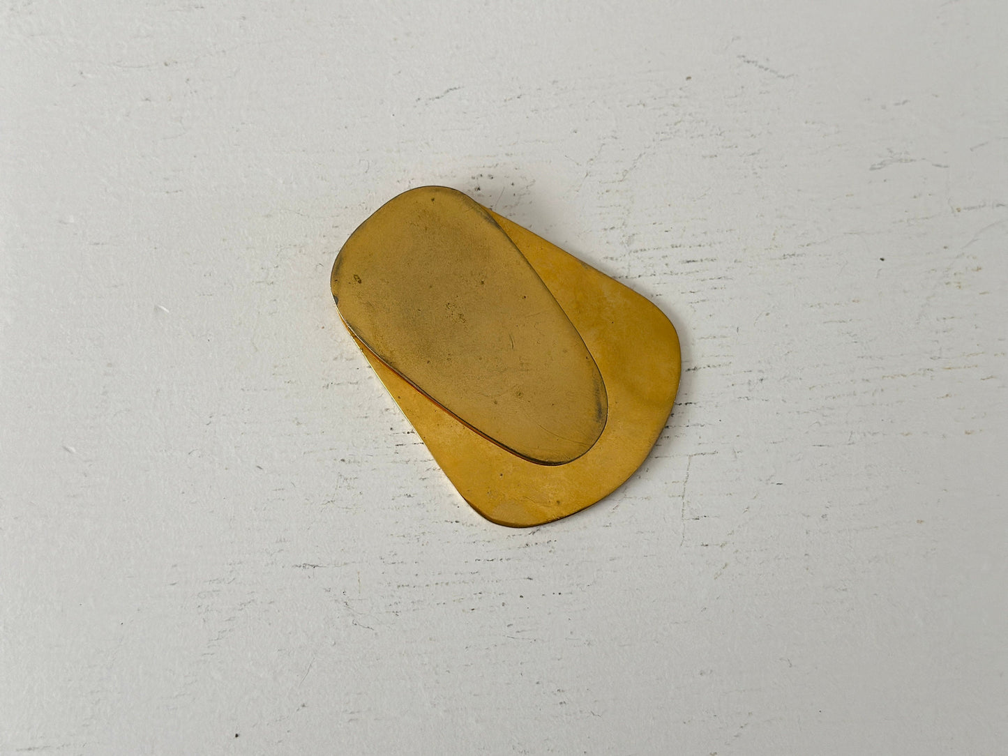1960s – A large brass plated modernist paperweight clip