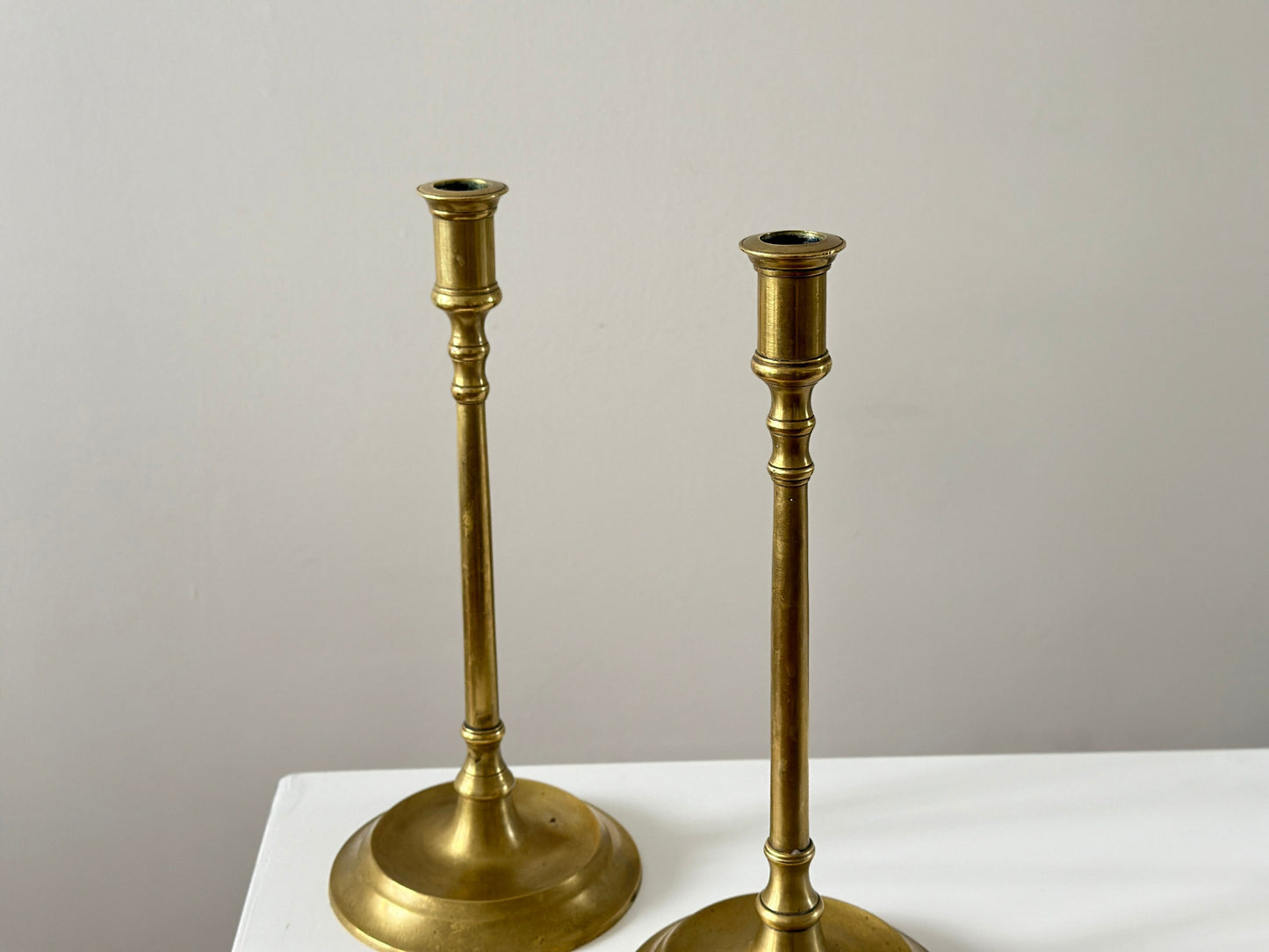 19th Century – Pair of tall solid brass candlesticks, made in England