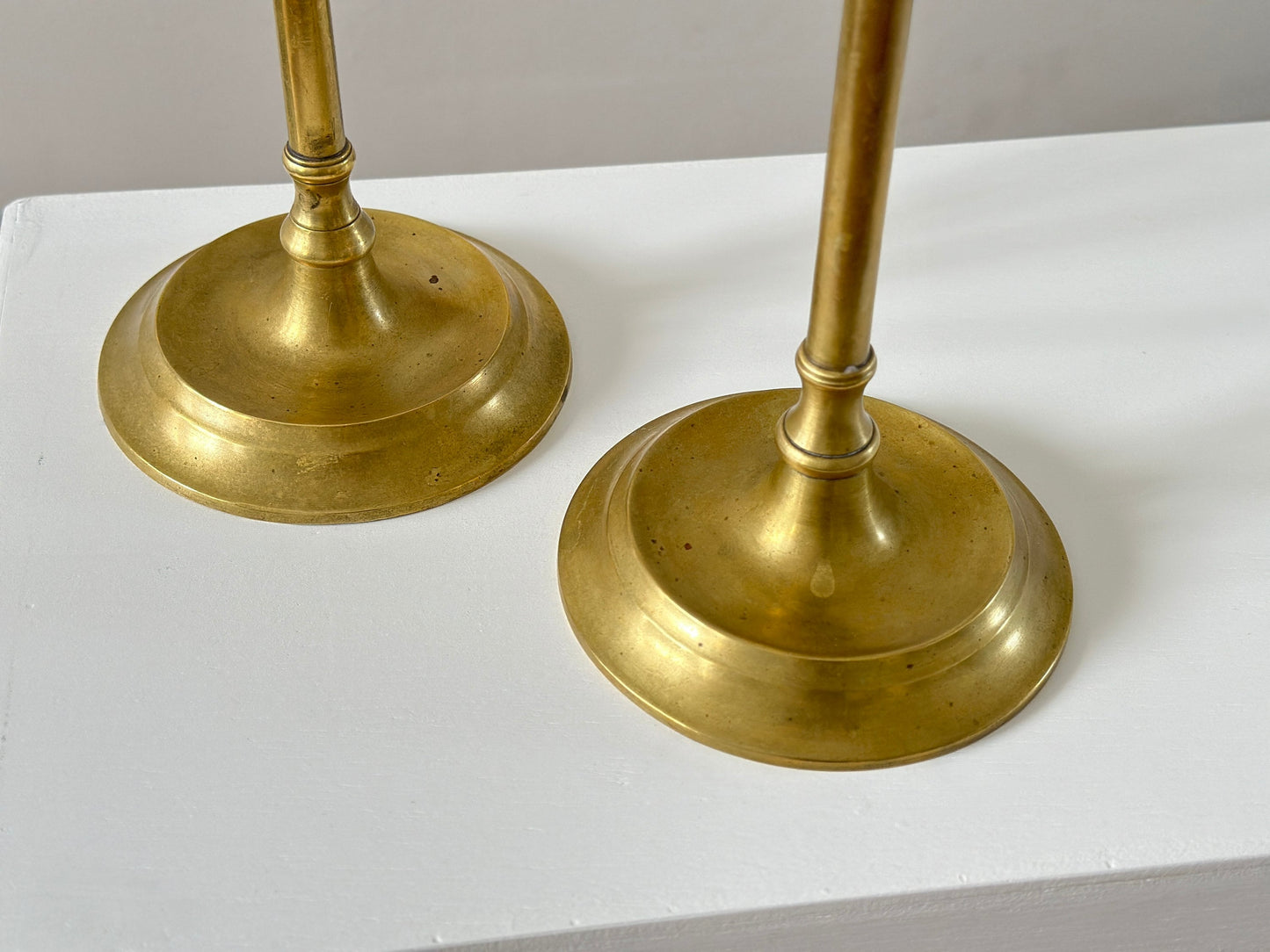 19th Century – Pair of tall solid brass candlesticks, made in England