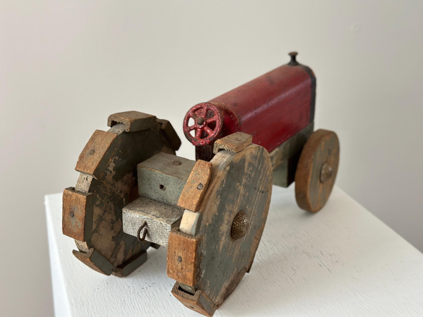 1930s – Primitive folk art toy tractor with red paint and cleated wheels