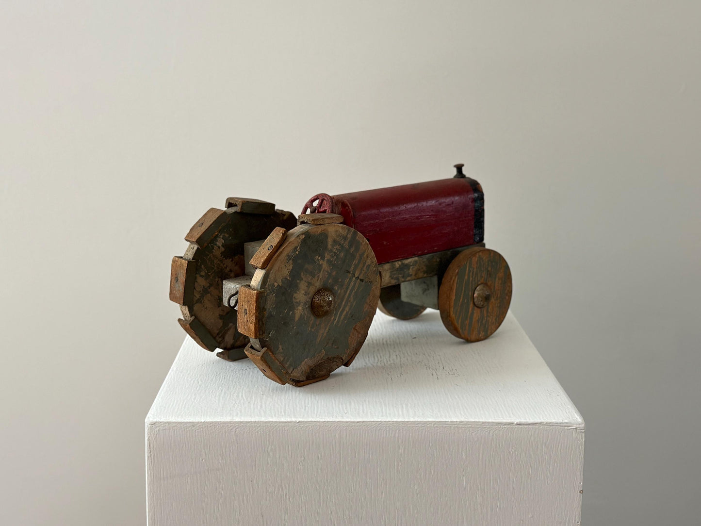 1930s – Primitive folk art toy tractor with red paint and cleated wheels