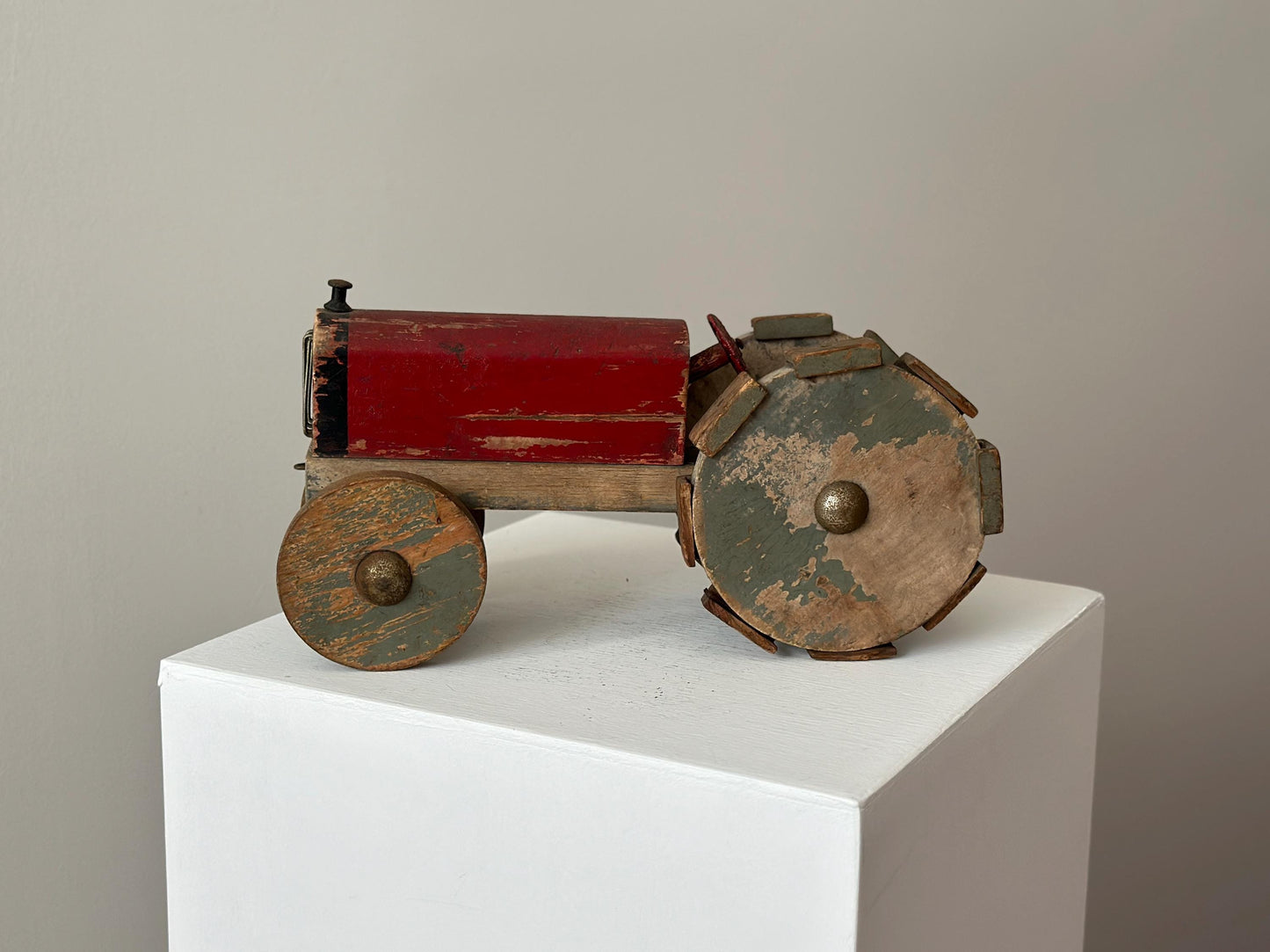 1930s – Primitive folk art toy tractor with red paint and cleated wheels