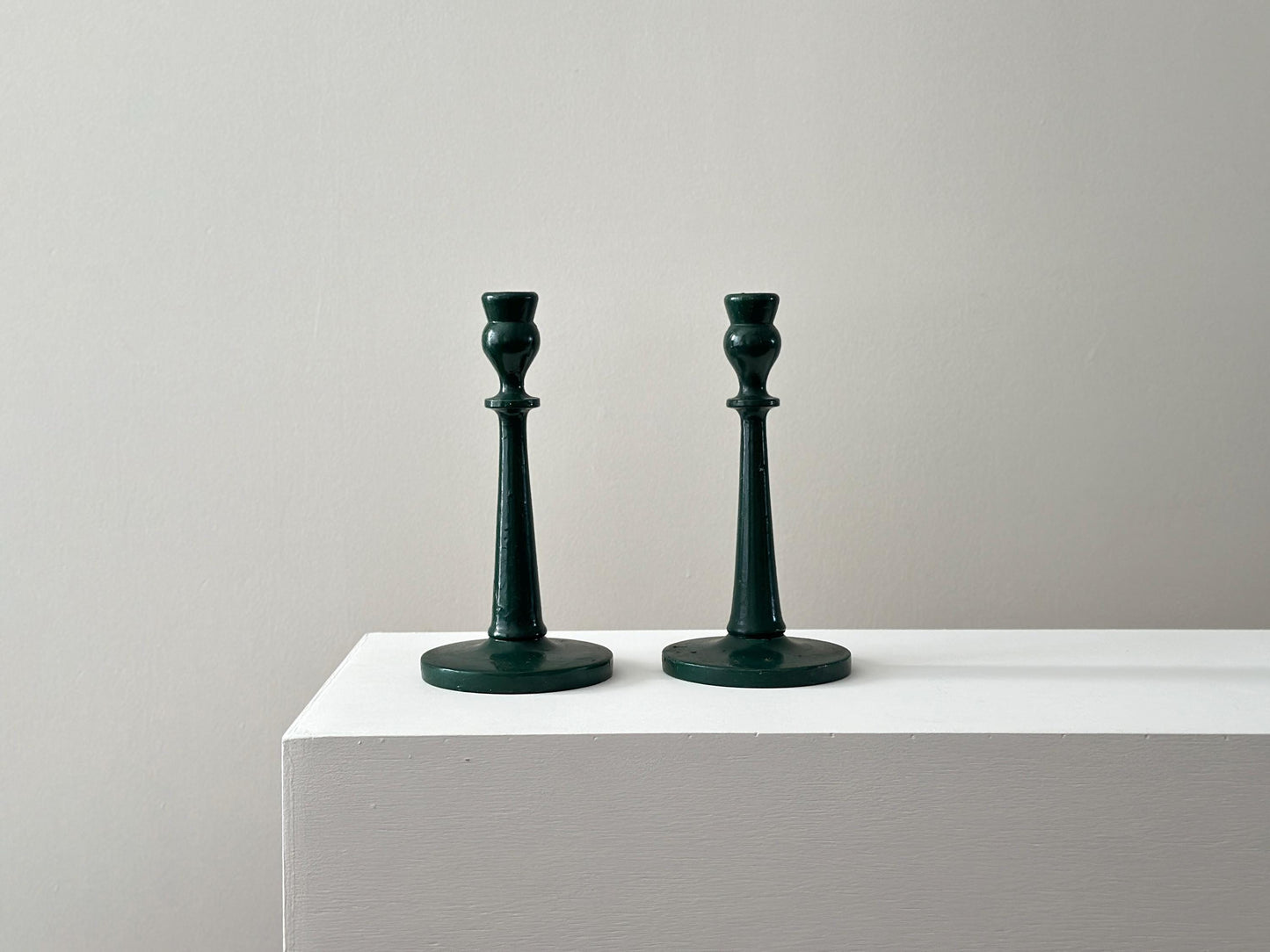Pair of antique half inch tapered candlestick holders with green paint, imperfect and rustic
