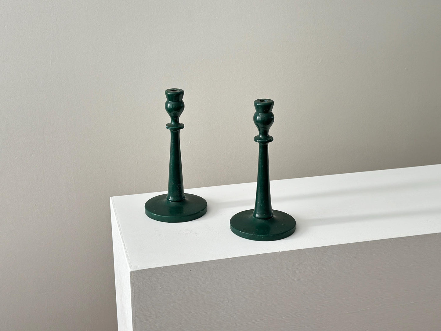 Pair of antique half inch tapered candlestick holders with green paint, imperfect and rustic
