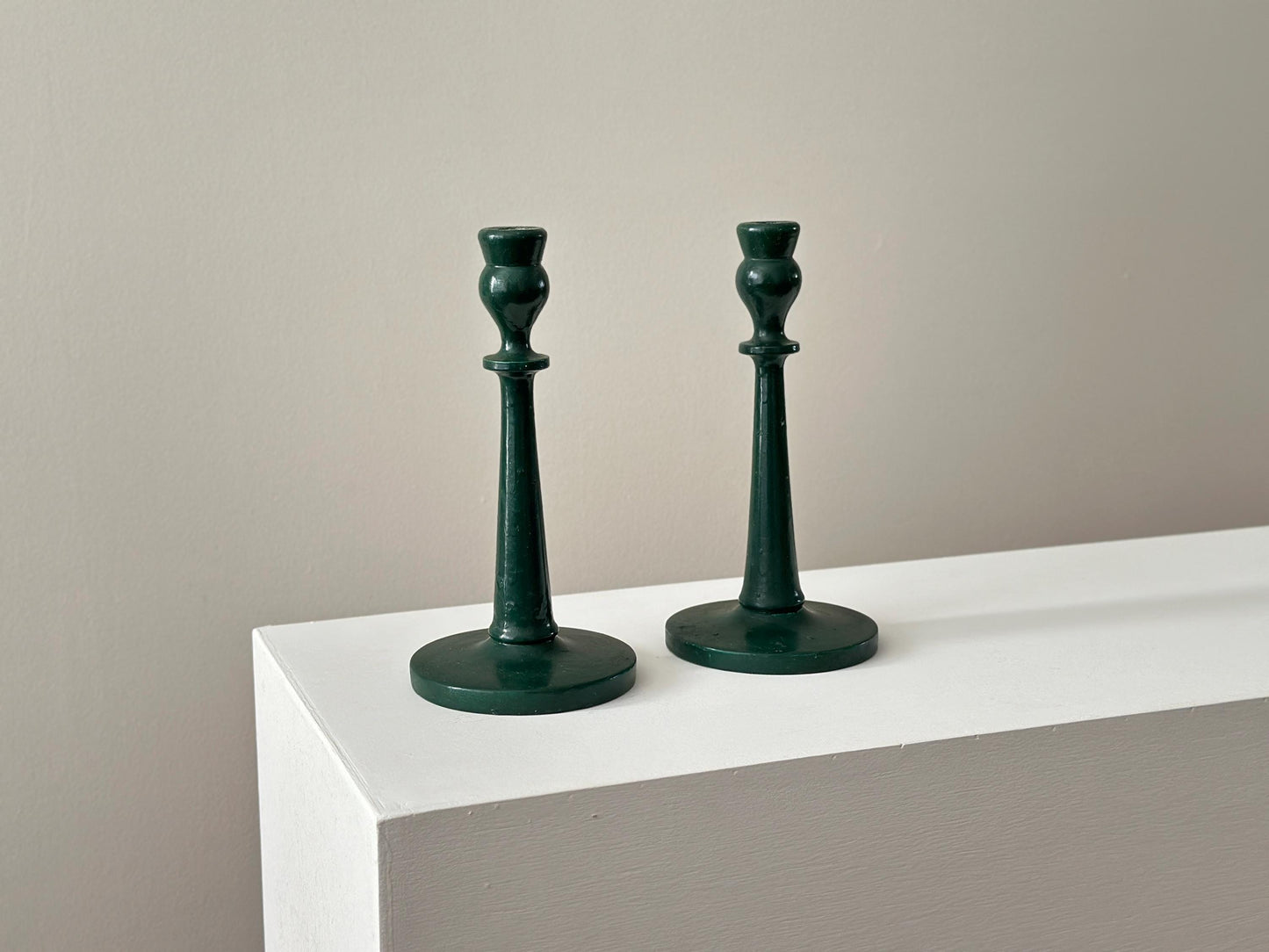 Pair of antique half inch tapered candlestick holders with green paint, imperfect and rustic
