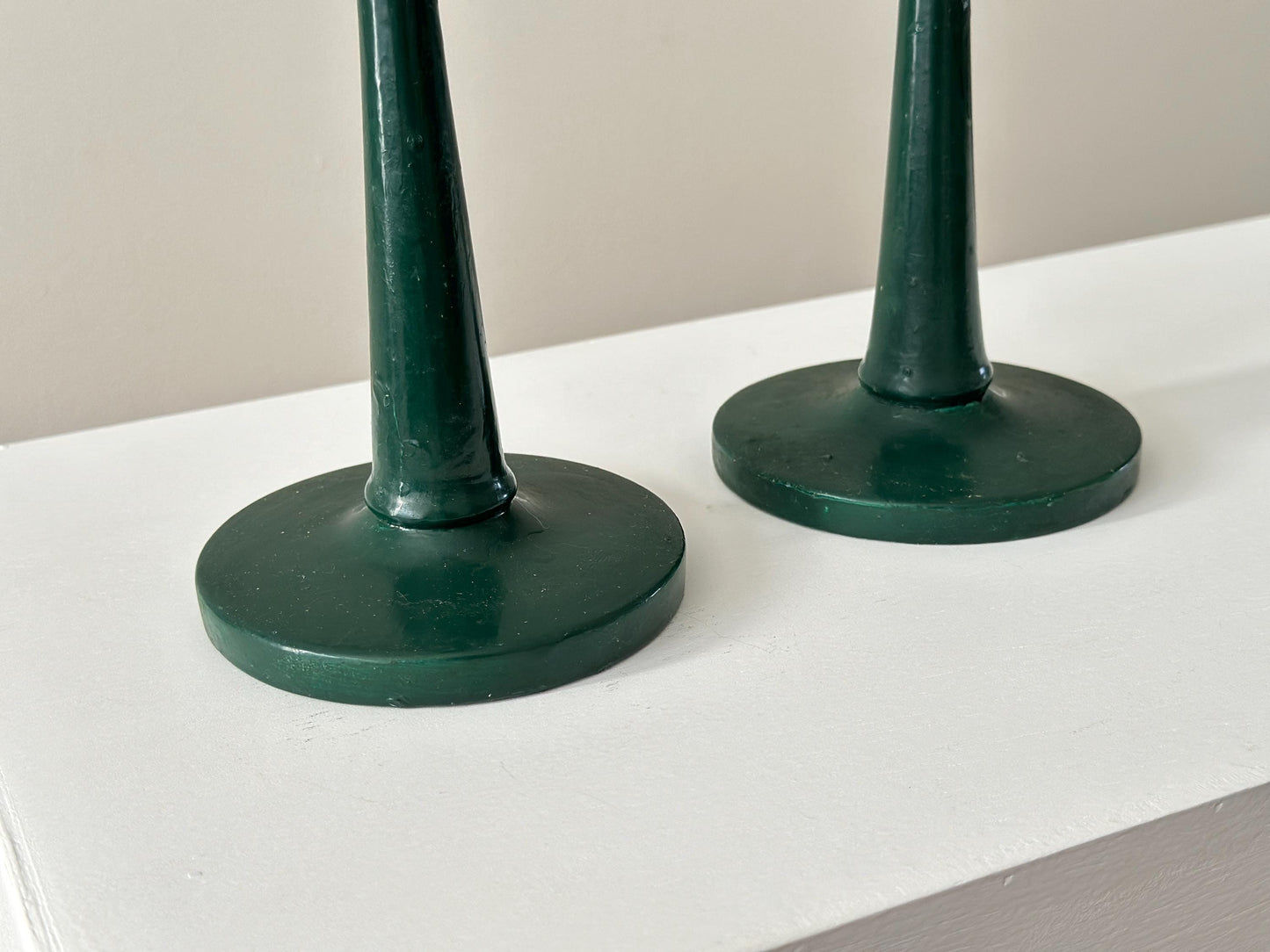 Pair of antique half inch tapered candlestick holders with green paint, imperfect and rustic