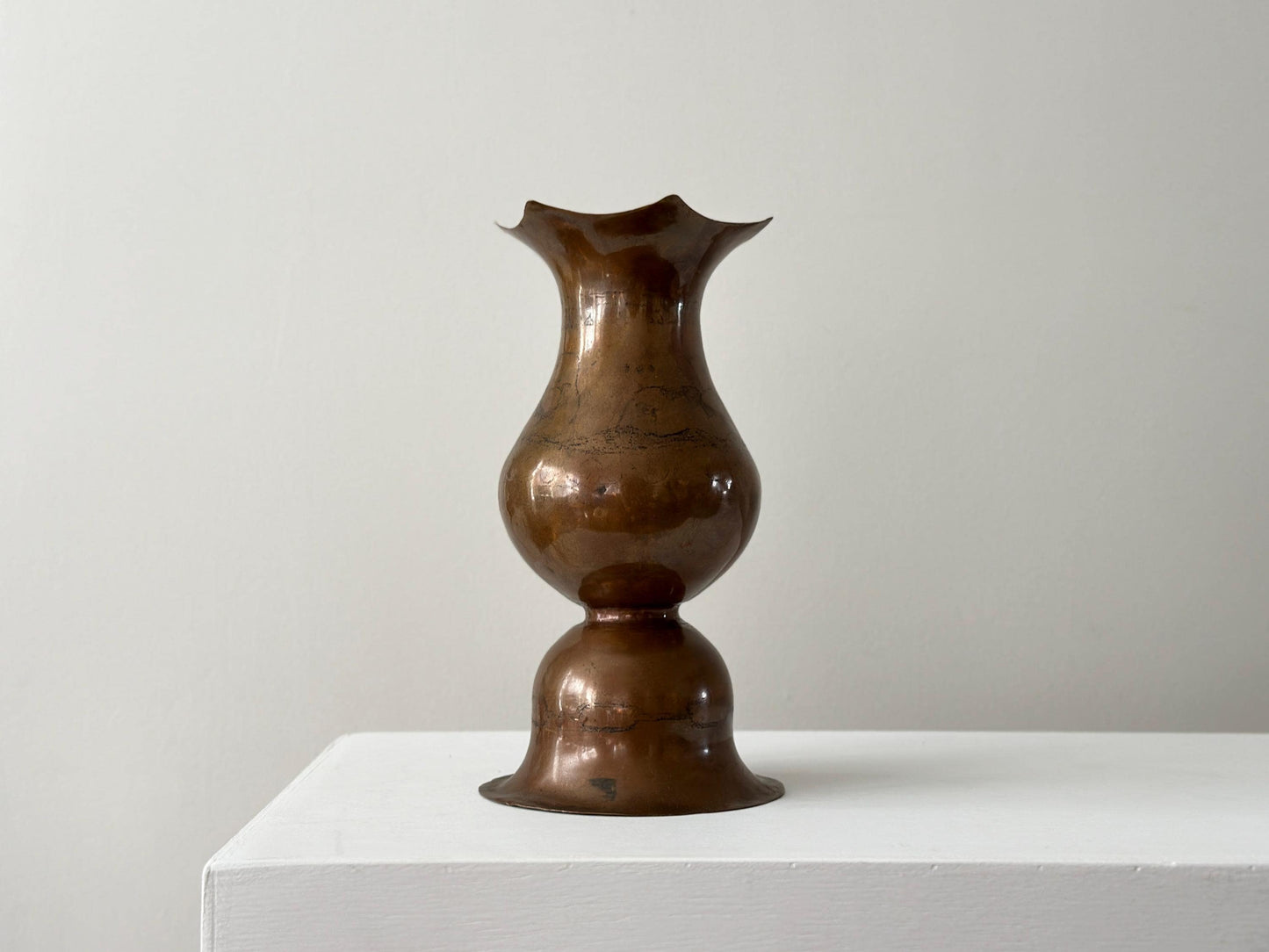 Vintage 9" hammered copper vase with bell shaped bottom and faint whale in waves artwork