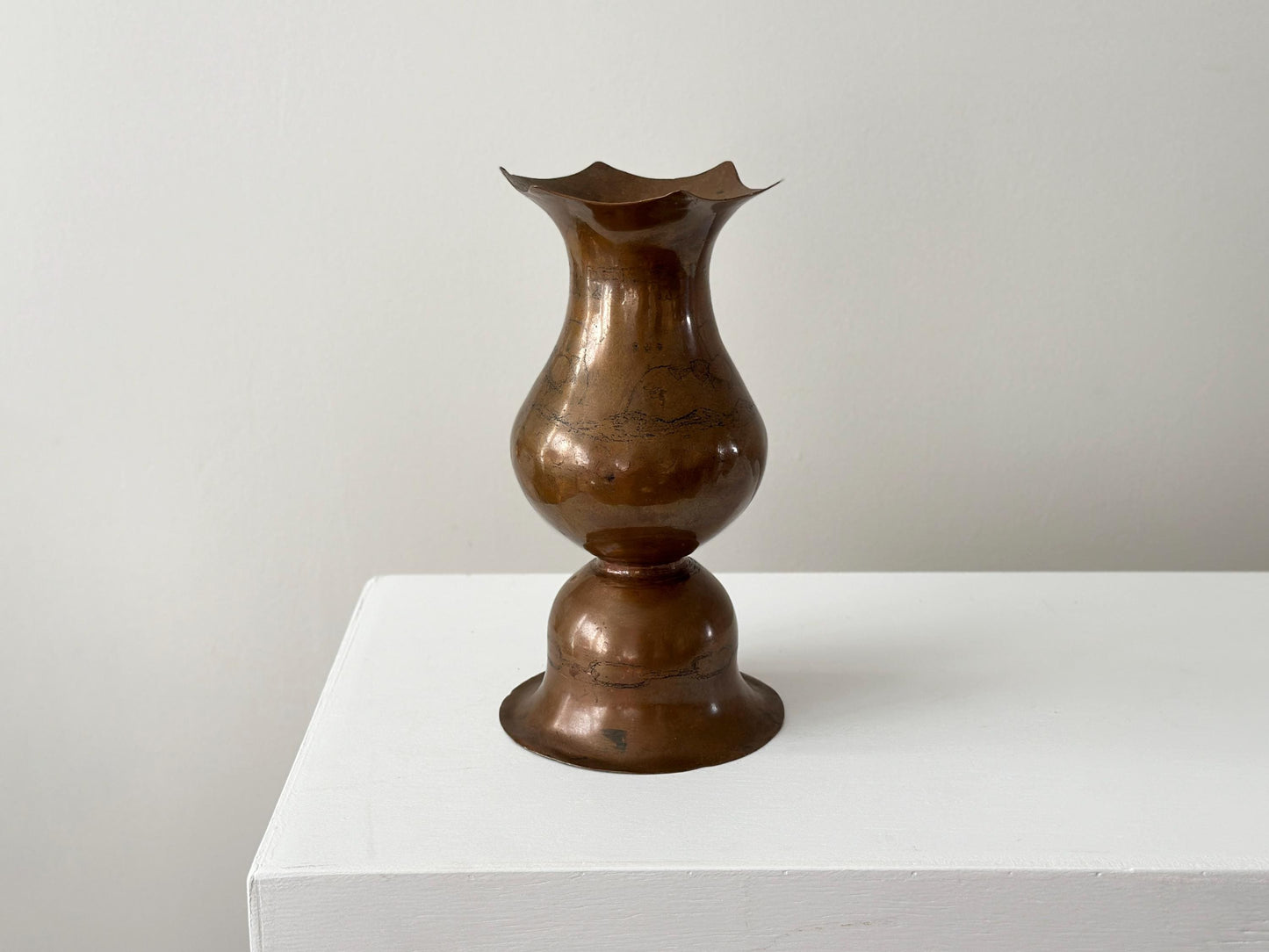 Vintage 9" hammered copper vase with bell shaped bottom and faint whale in waves artwork