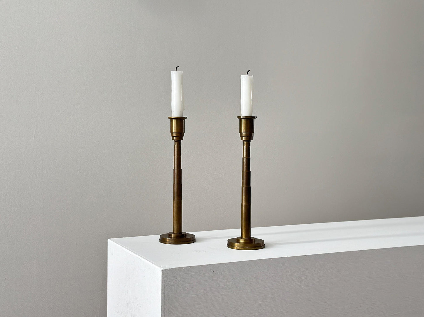 1930s – Pair of solid brass Art Deco candleholders with tiered stepped design