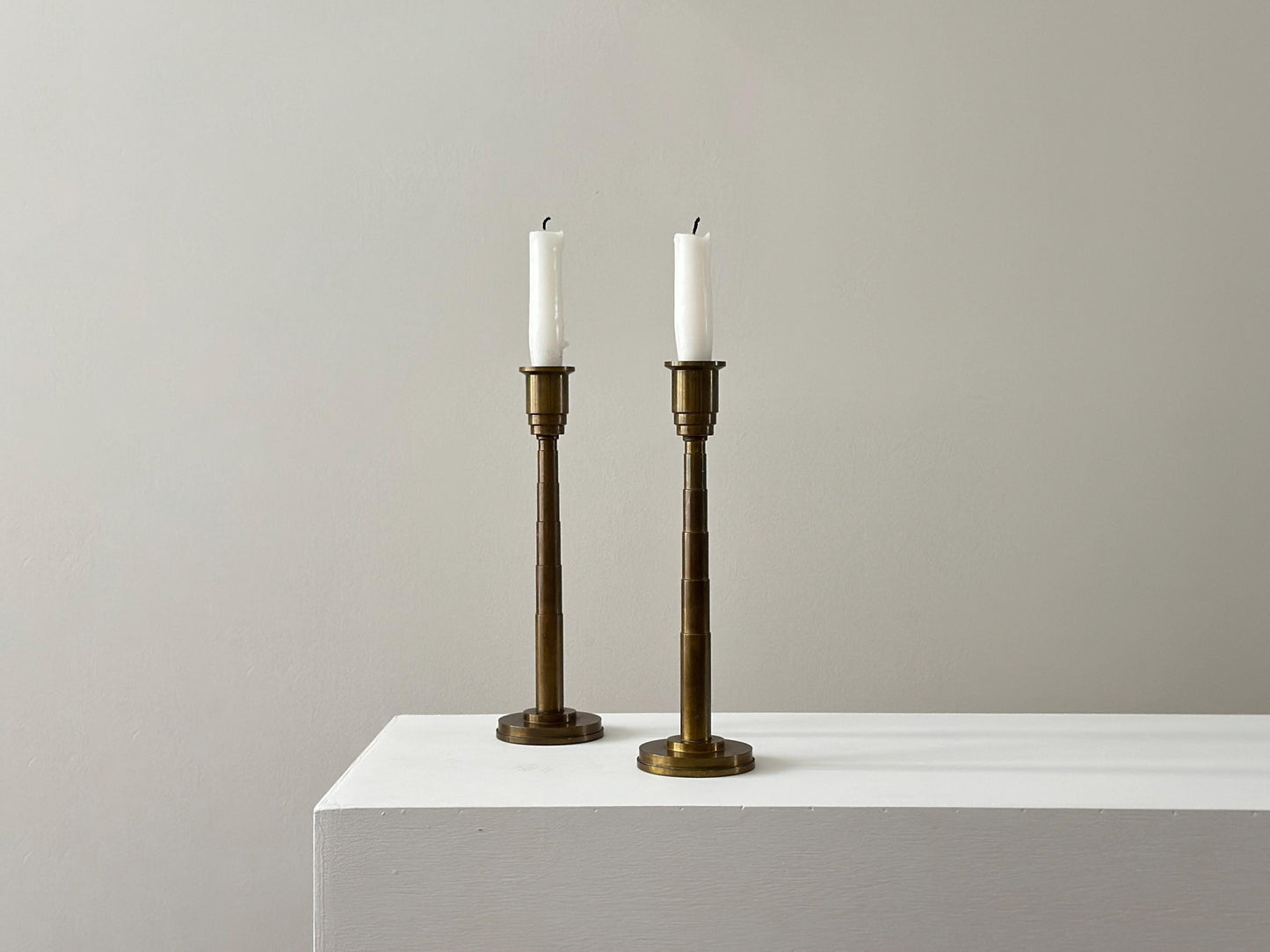 1930s – Pair of solid brass Art Deco candleholders with tiered stepped design