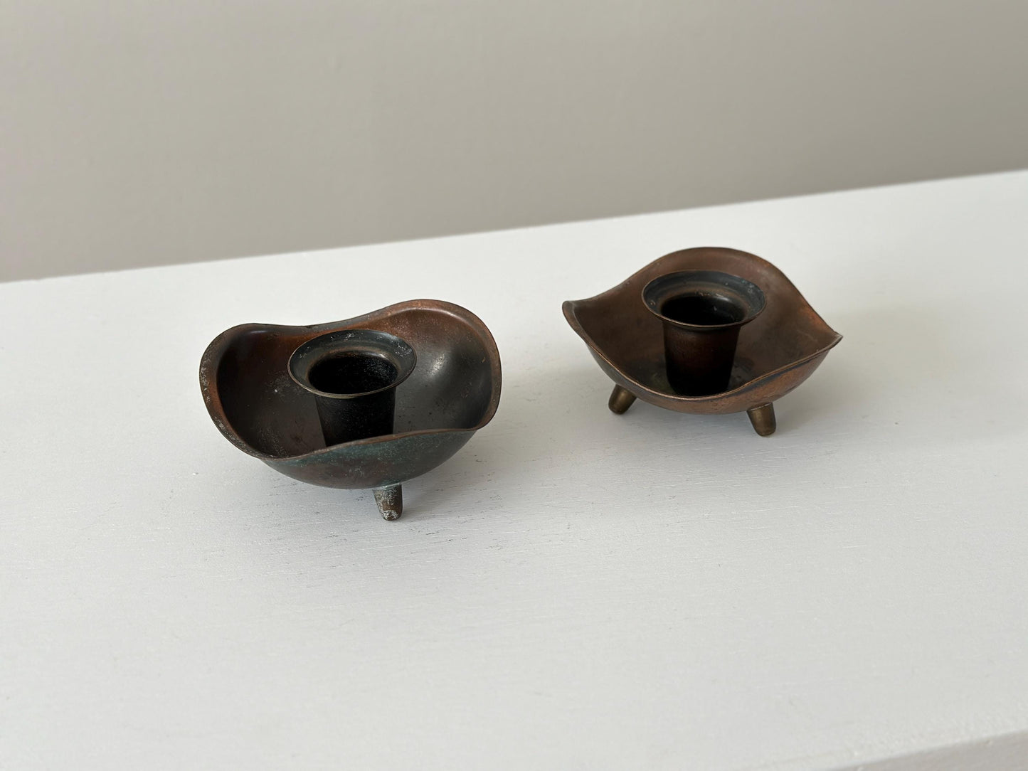 Pair of candlestick holders with heavy patina