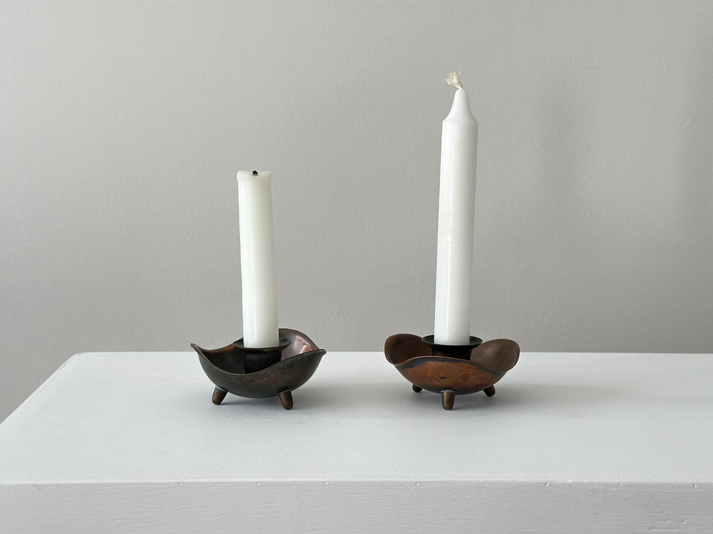 Pair of candlestick holders with heavy patina