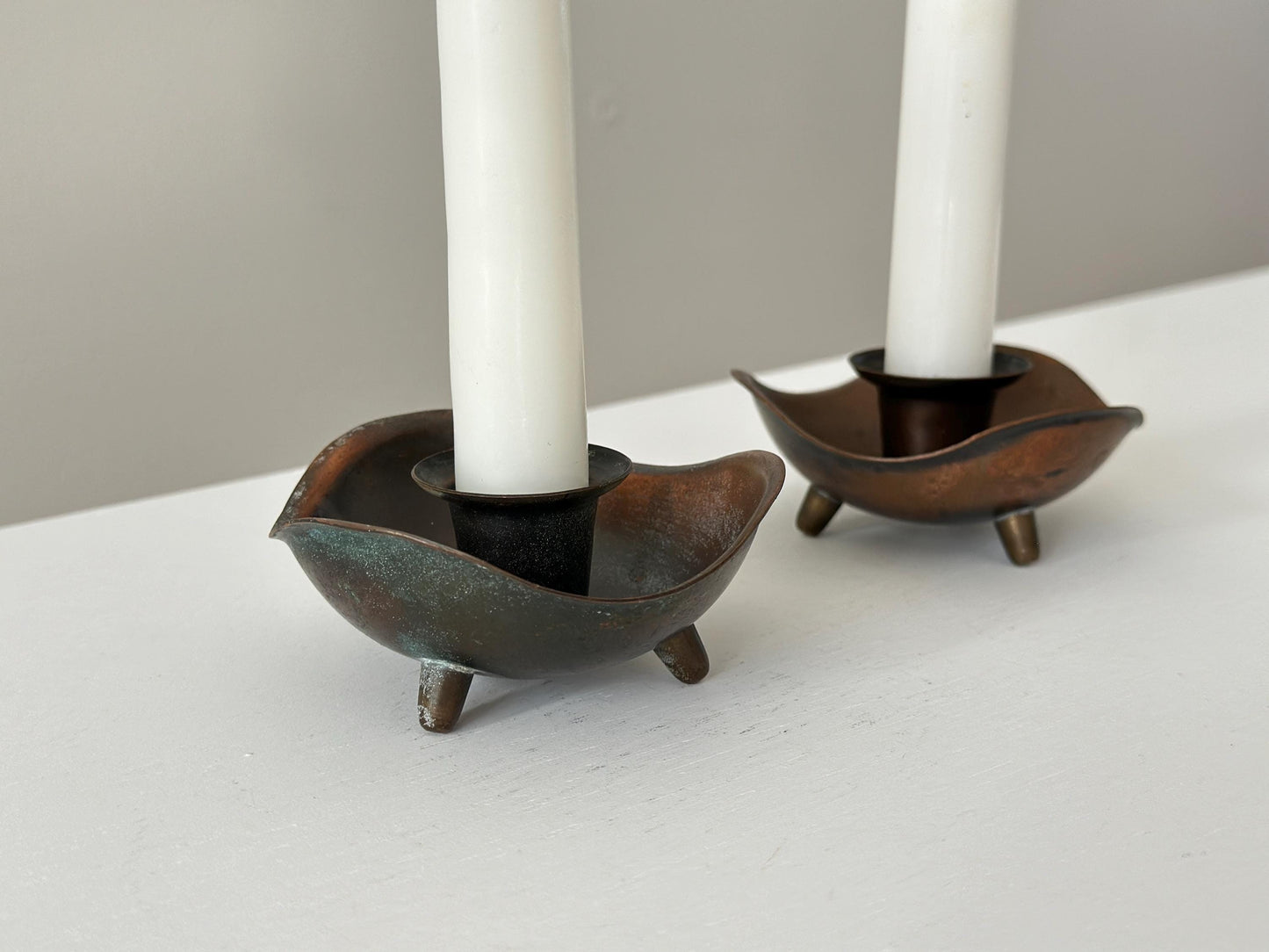 Pair of candlestick holders with heavy patina