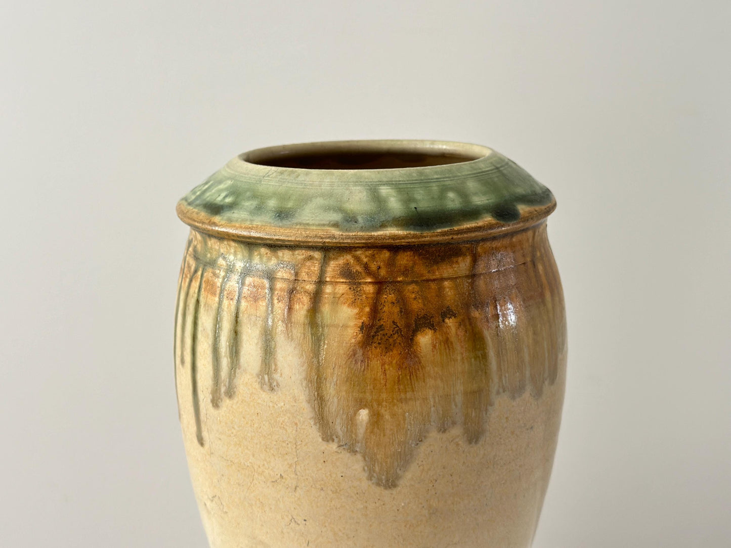 Vintage 10" studio pottery vase with green drip glaze and arts and crafts influence