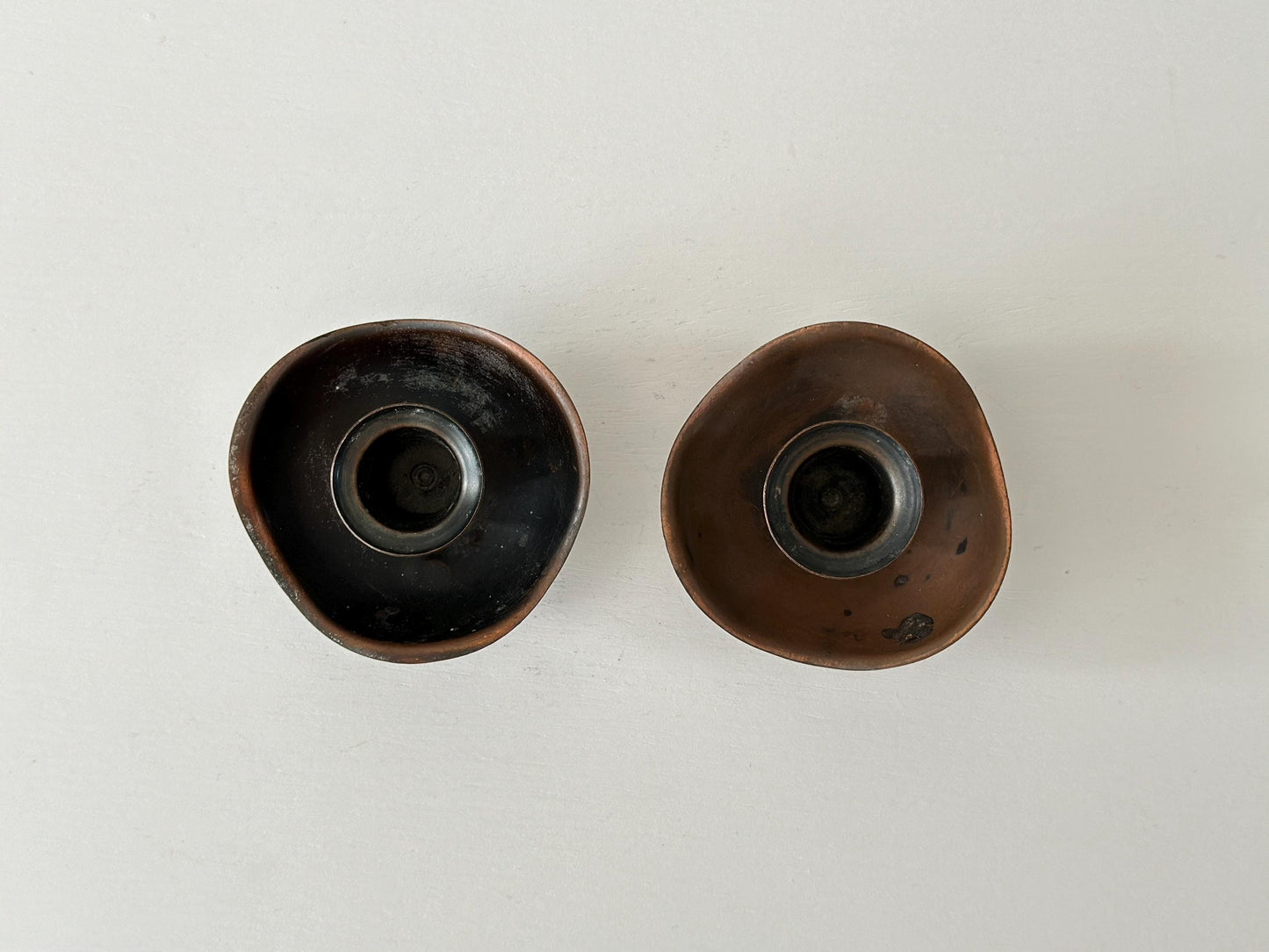 Pair of candlestick holders with heavy patina