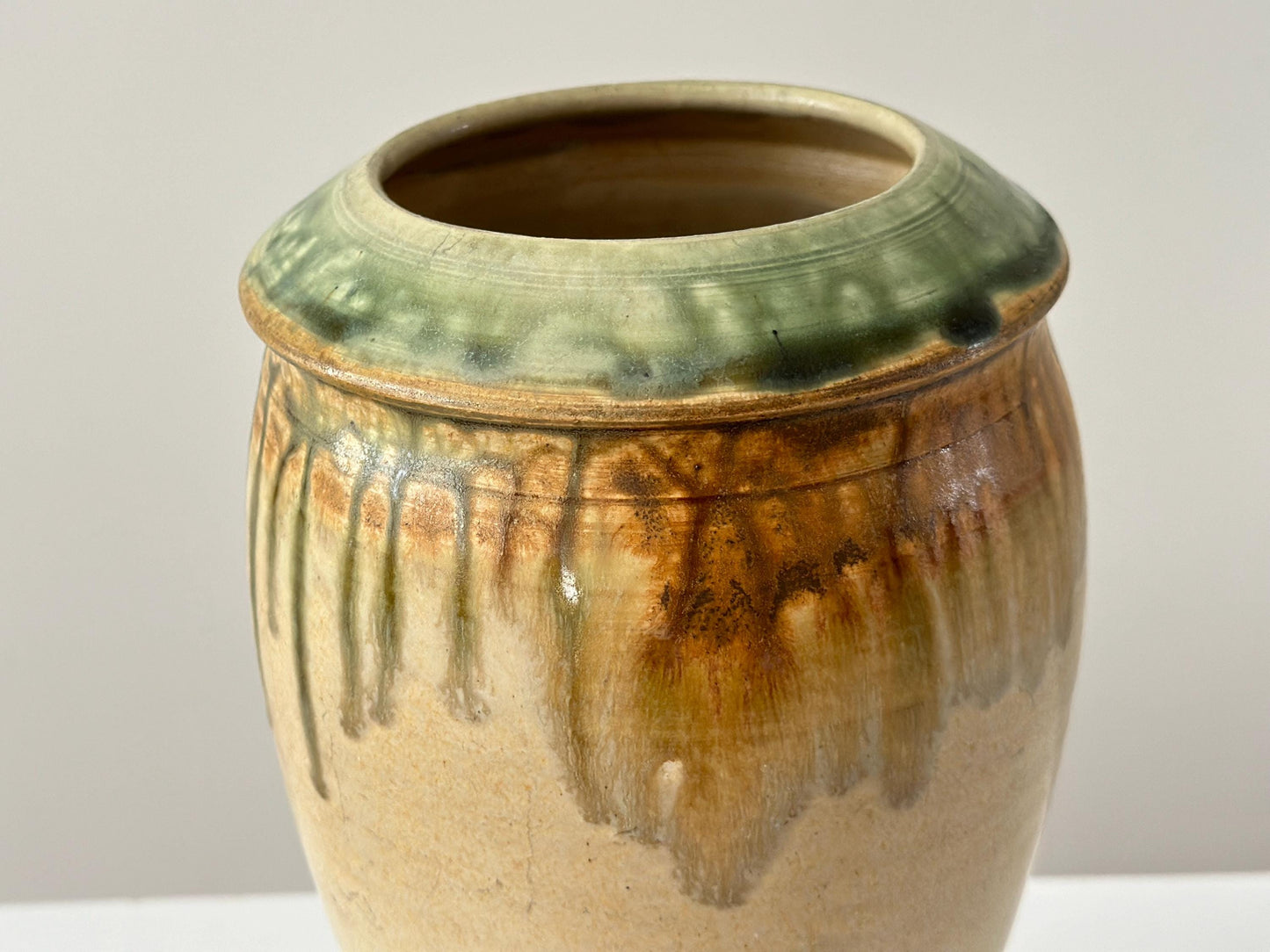Vintage 10" studio pottery vase with green drip glaze and arts and crafts influence