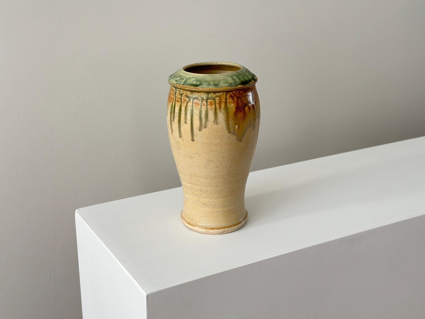 Vintage 10" studio pottery vase with green drip glaze and arts and crafts influence