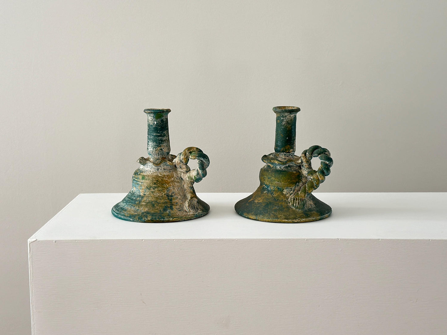 Pair of vintage verdigris terracotta candlestick holders
