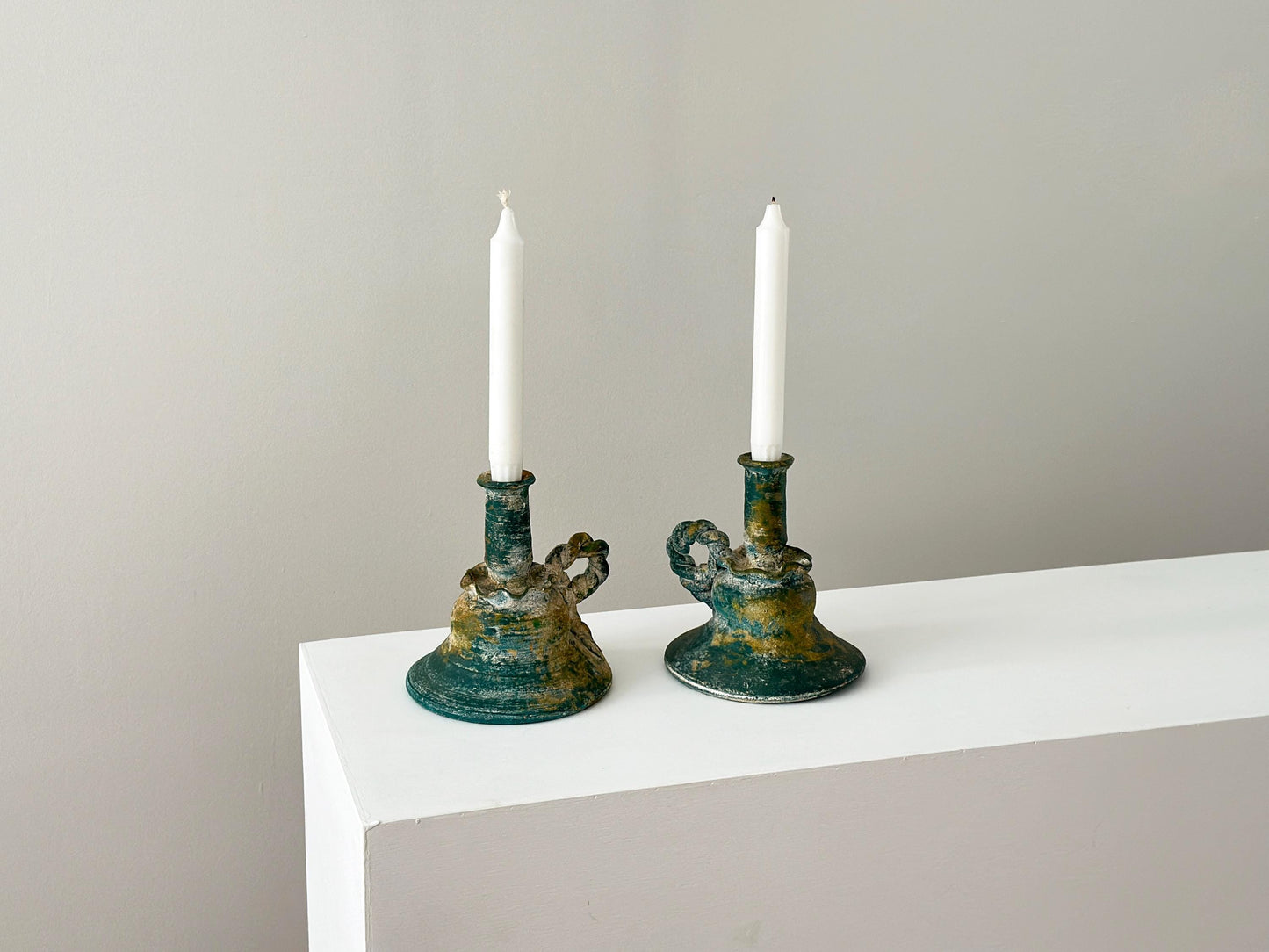 Pair of vintage verdigris terracotta candlestick holders