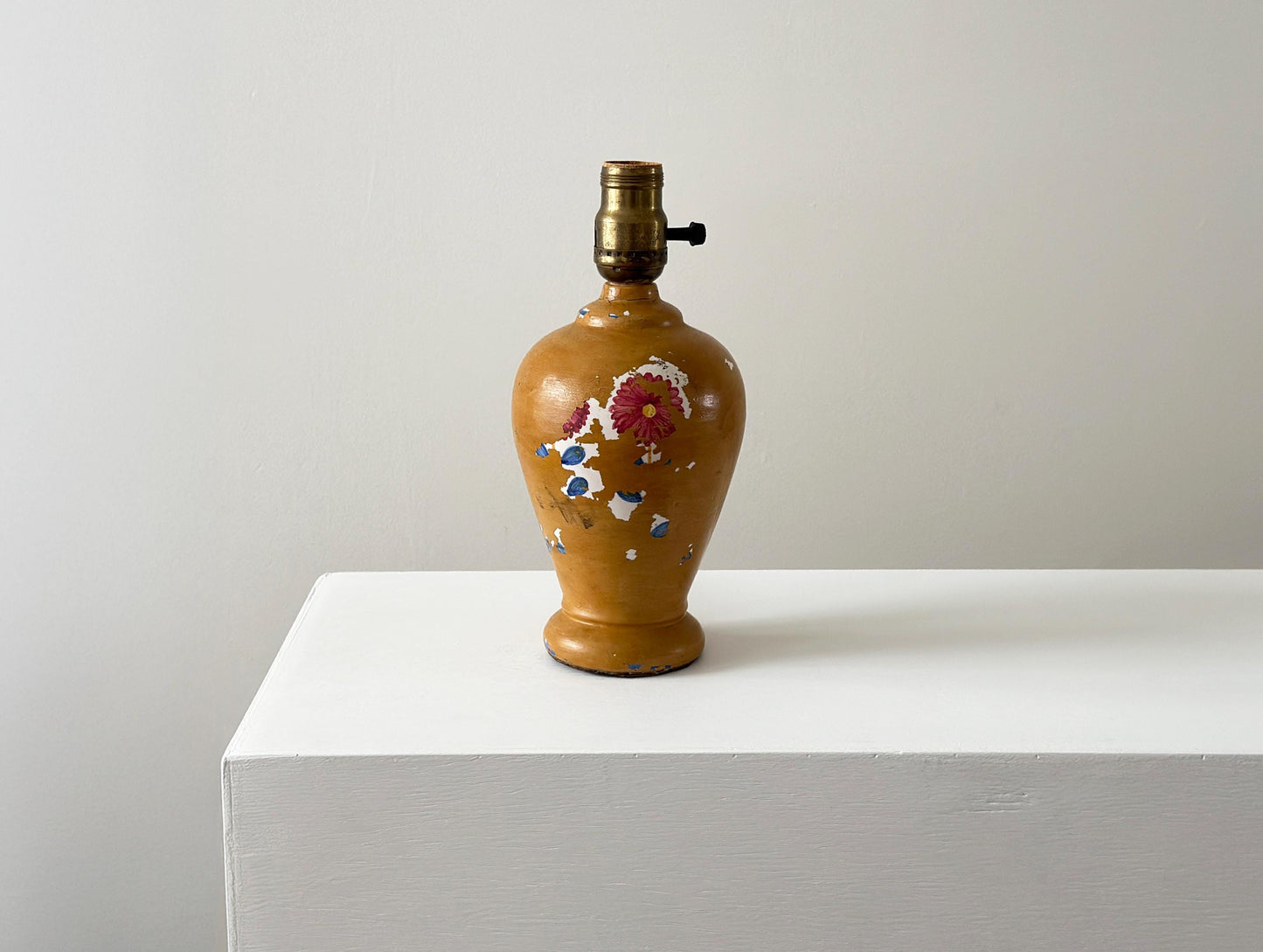 Antique porcelain lamp with weathered patina and chipped paint