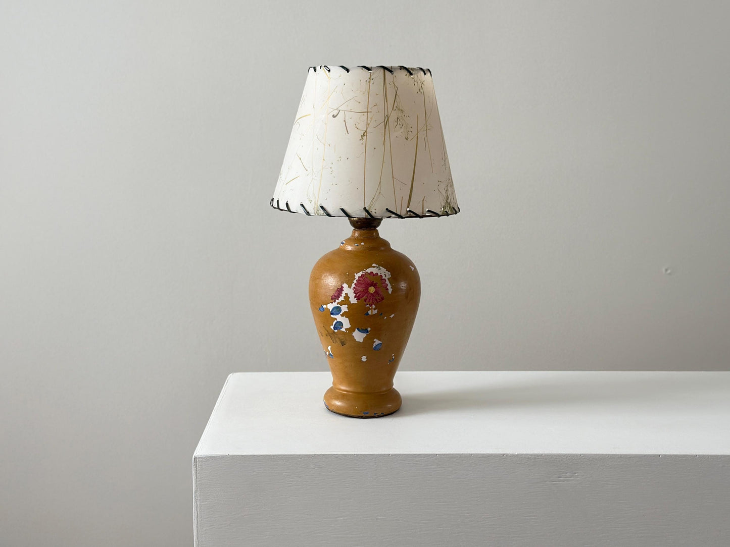 Antique porcelain lamp with weathered patina and chipped paint
