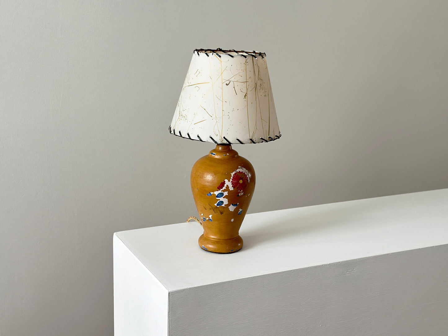 Antique porcelain lamp with weathered patina and chipped paint