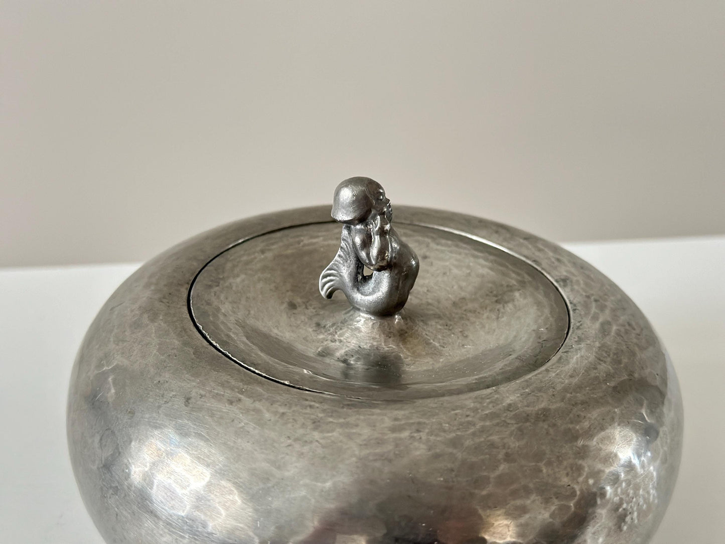 1920s – Danish rounded form hammered pewter box with merman lid