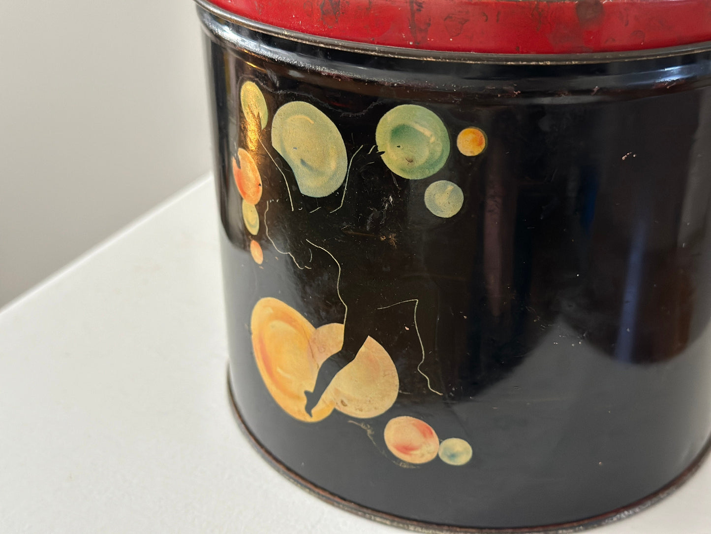 1940s – Tin canister with pinup dancer graphics