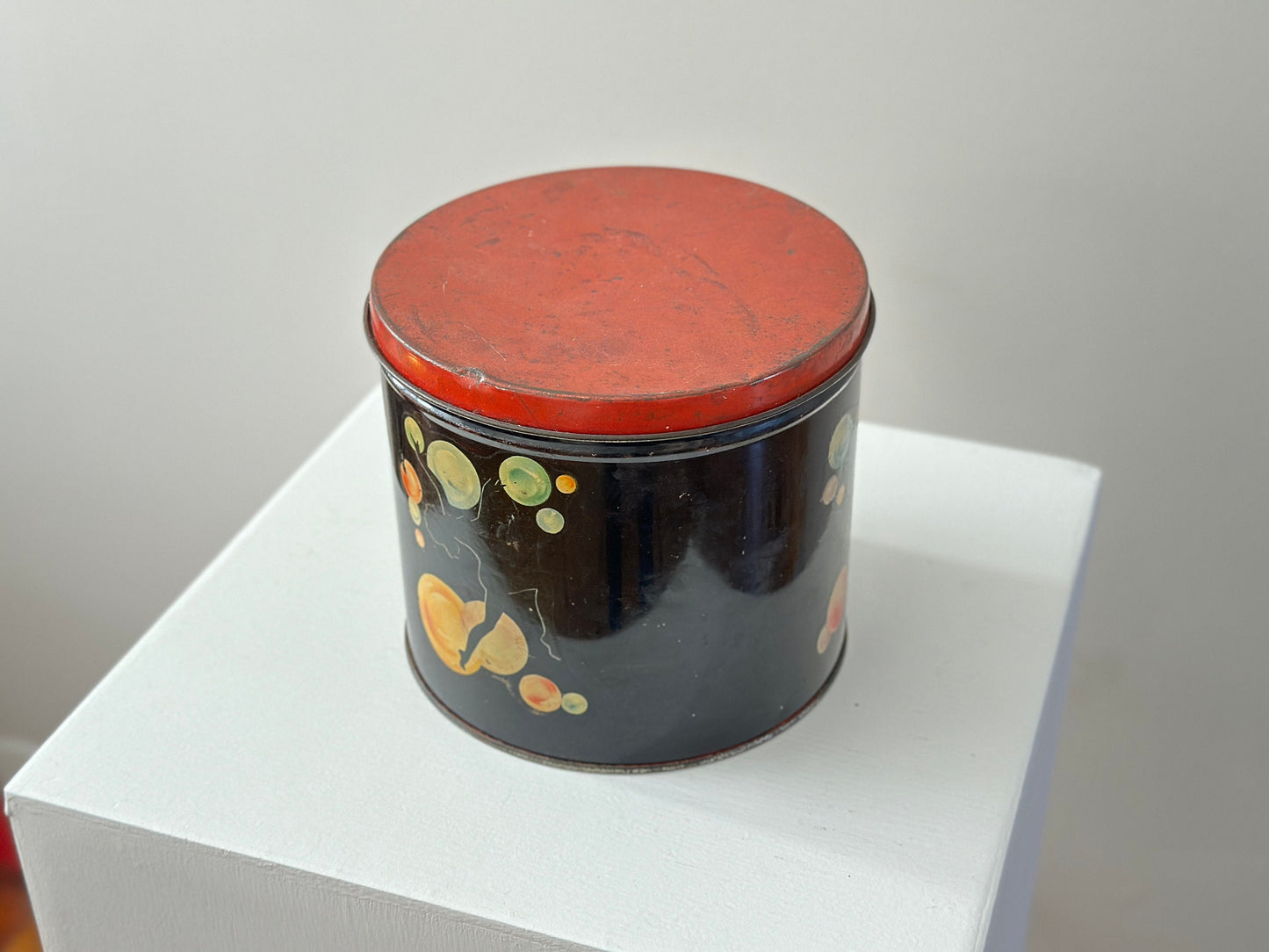 1940s – Tin canister with pinup dancer graphics