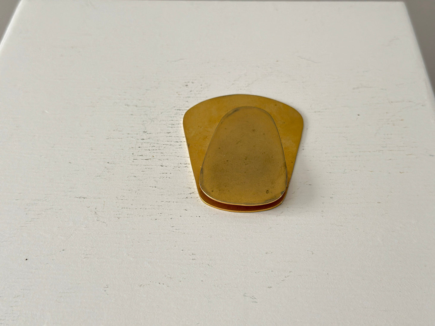 1960s – A large brass plated modernist paperweight clip