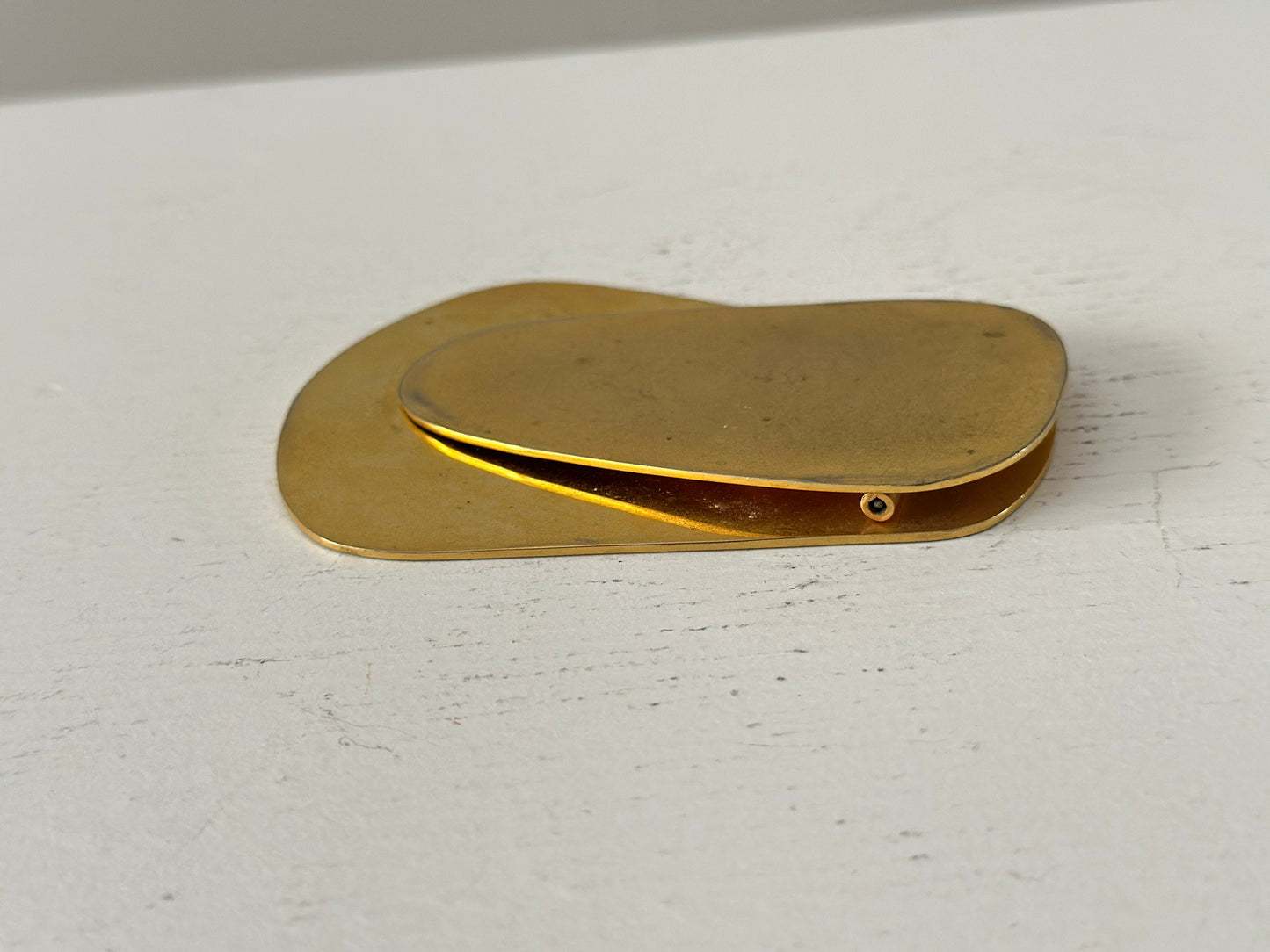 1960s – A large brass plated modernist paperweight clip