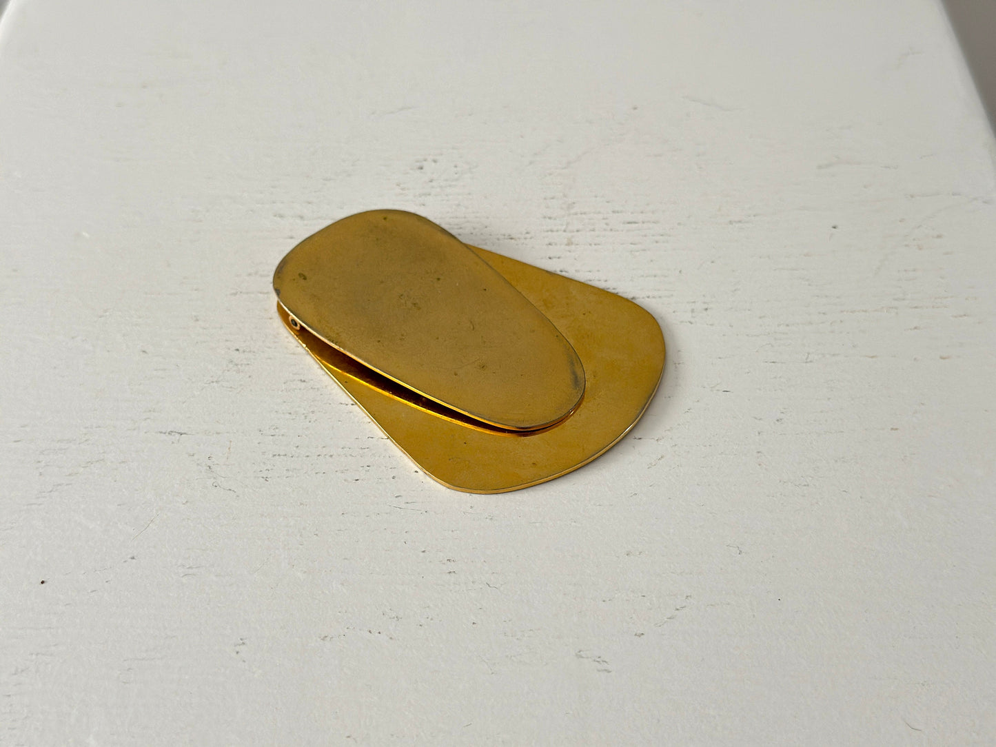 1960s – A large brass plated modernist paperweight clip