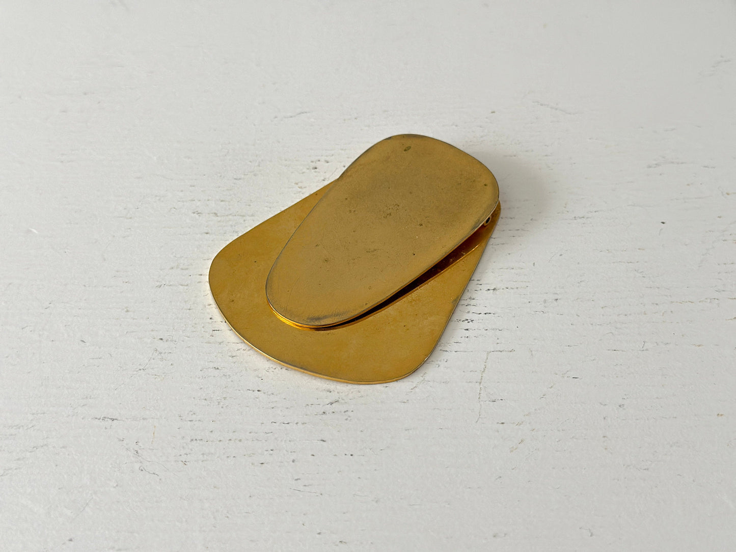 1960s – A large brass plated modernist paperweight clip