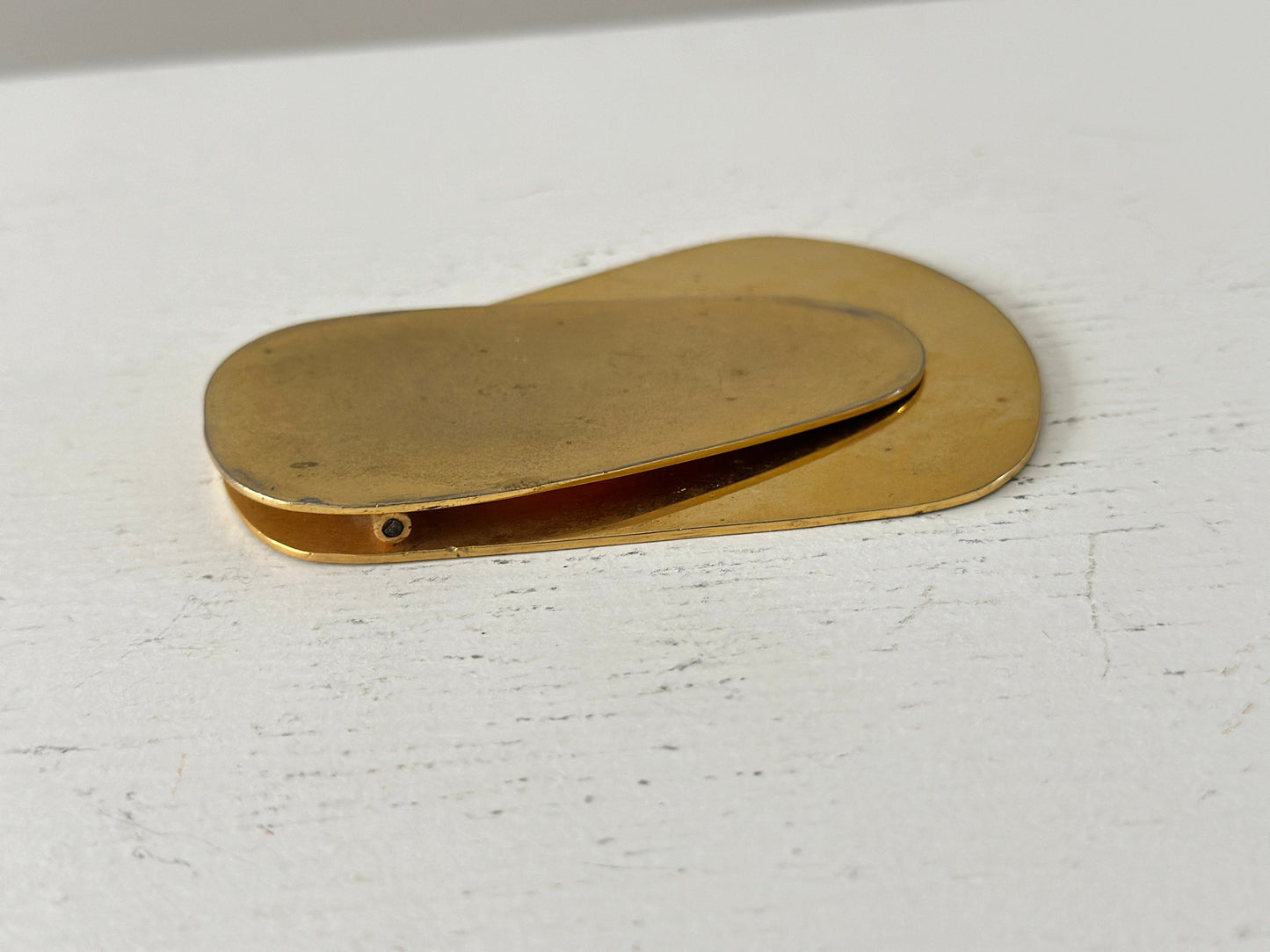 1960s – A large brass plated modernist paperweight clip