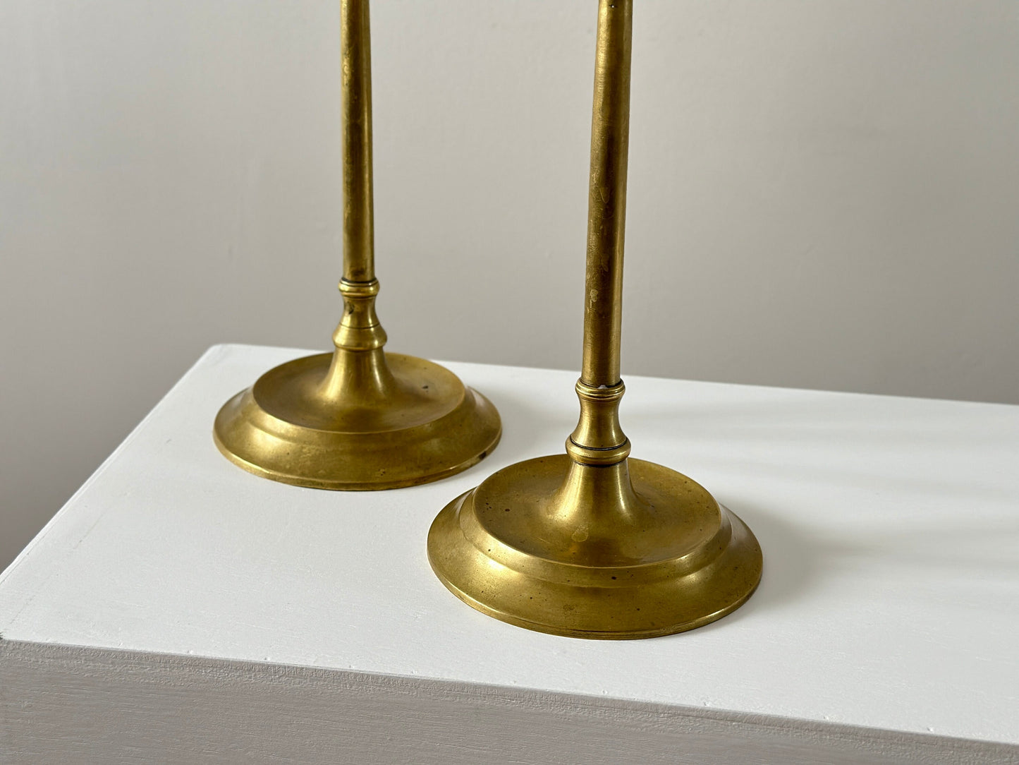 19th Century – Pair of tall solid brass candlesticks, made in England