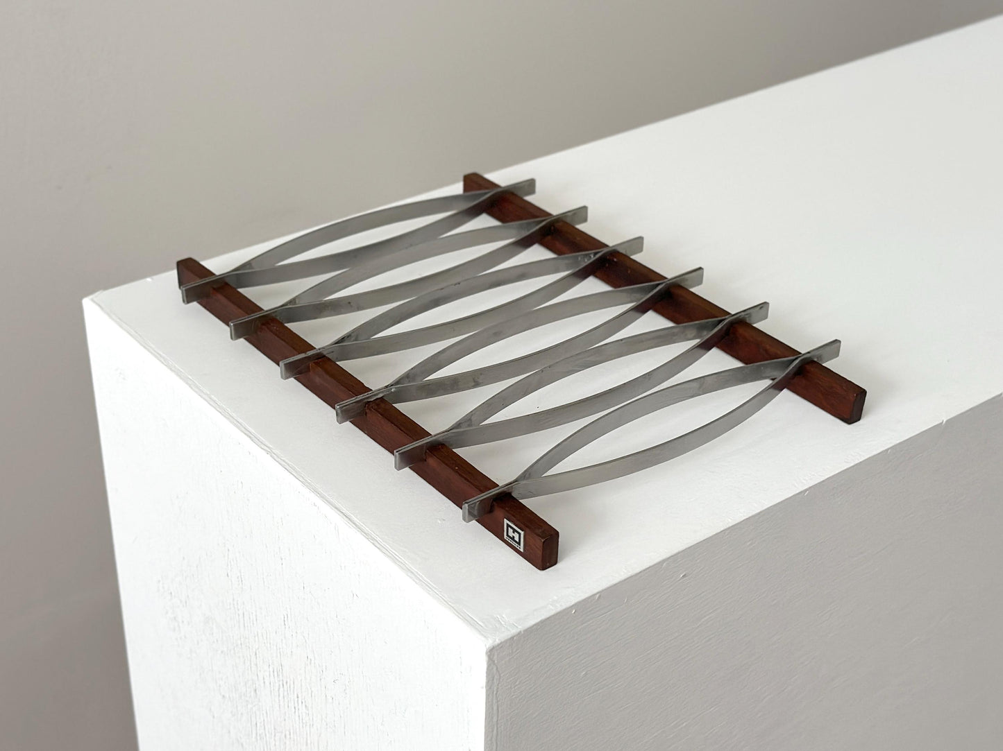 1960s – Mid-Century Brazilian stainless steel and rosewood trivet by Hercules