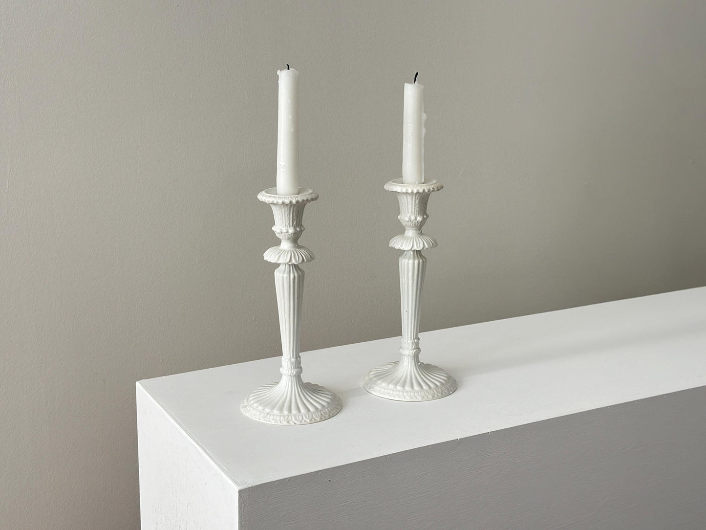 1959 – Pair of Mid Century Italian neoclassical Corinthian column white glazed ceramic candlesticks imported by Bonwit Teller