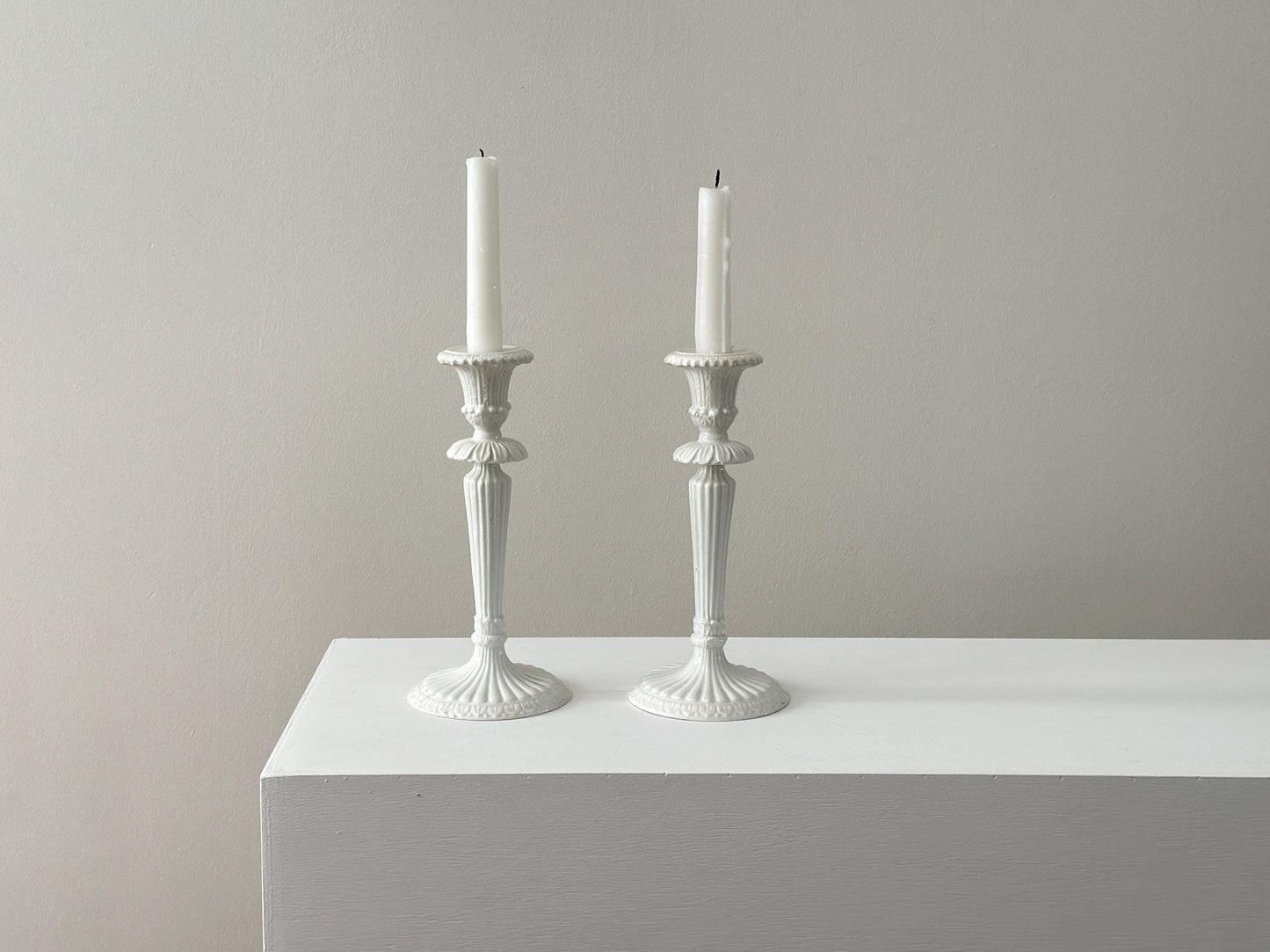 1959 – Pair of Mid Century Italian neoclassical Corinthian column white glazed ceramic candlesticks imported by Bonwit Teller