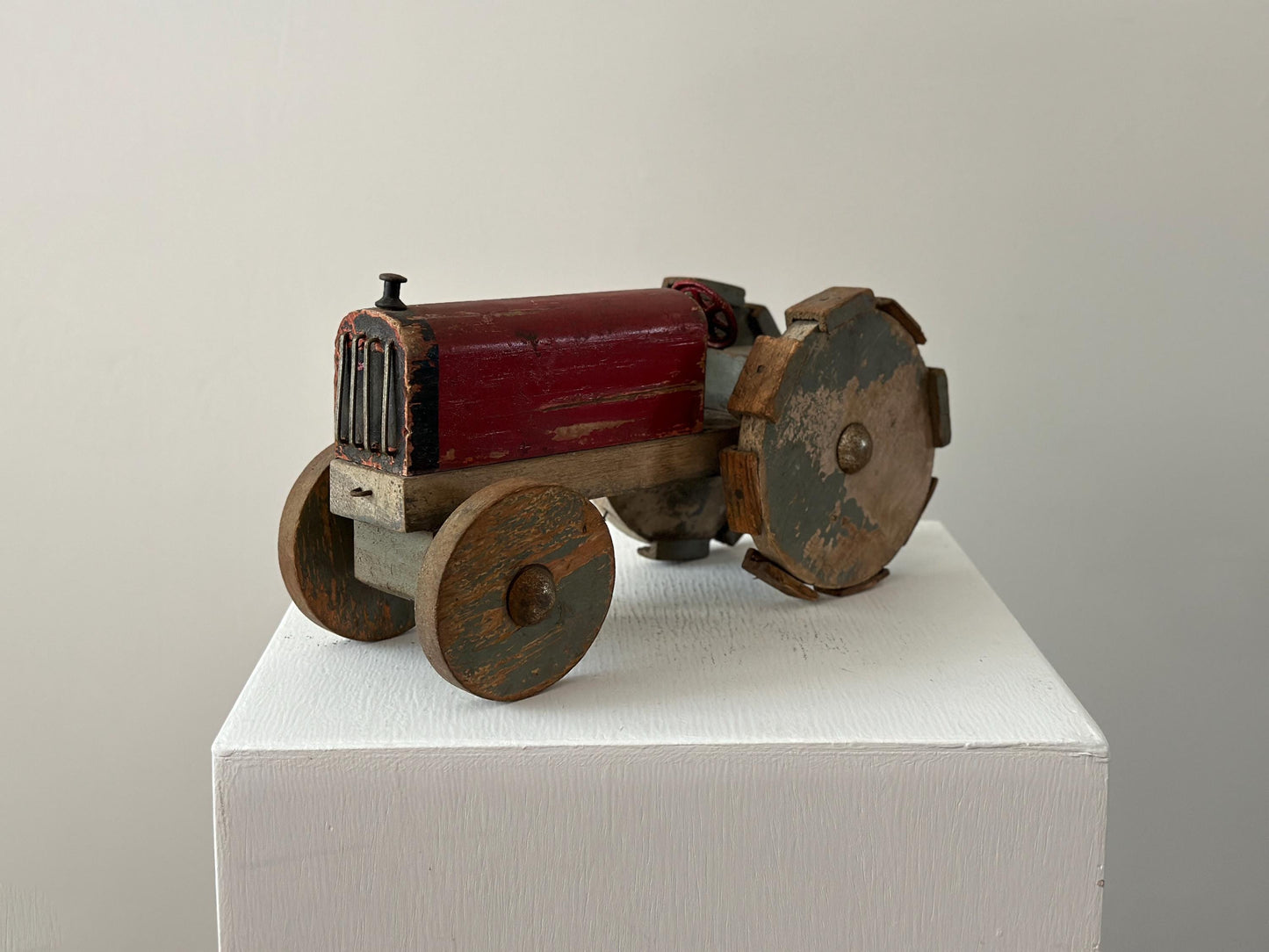 1930s – Primitive folk art toy tractor with red paint and cleated wheels