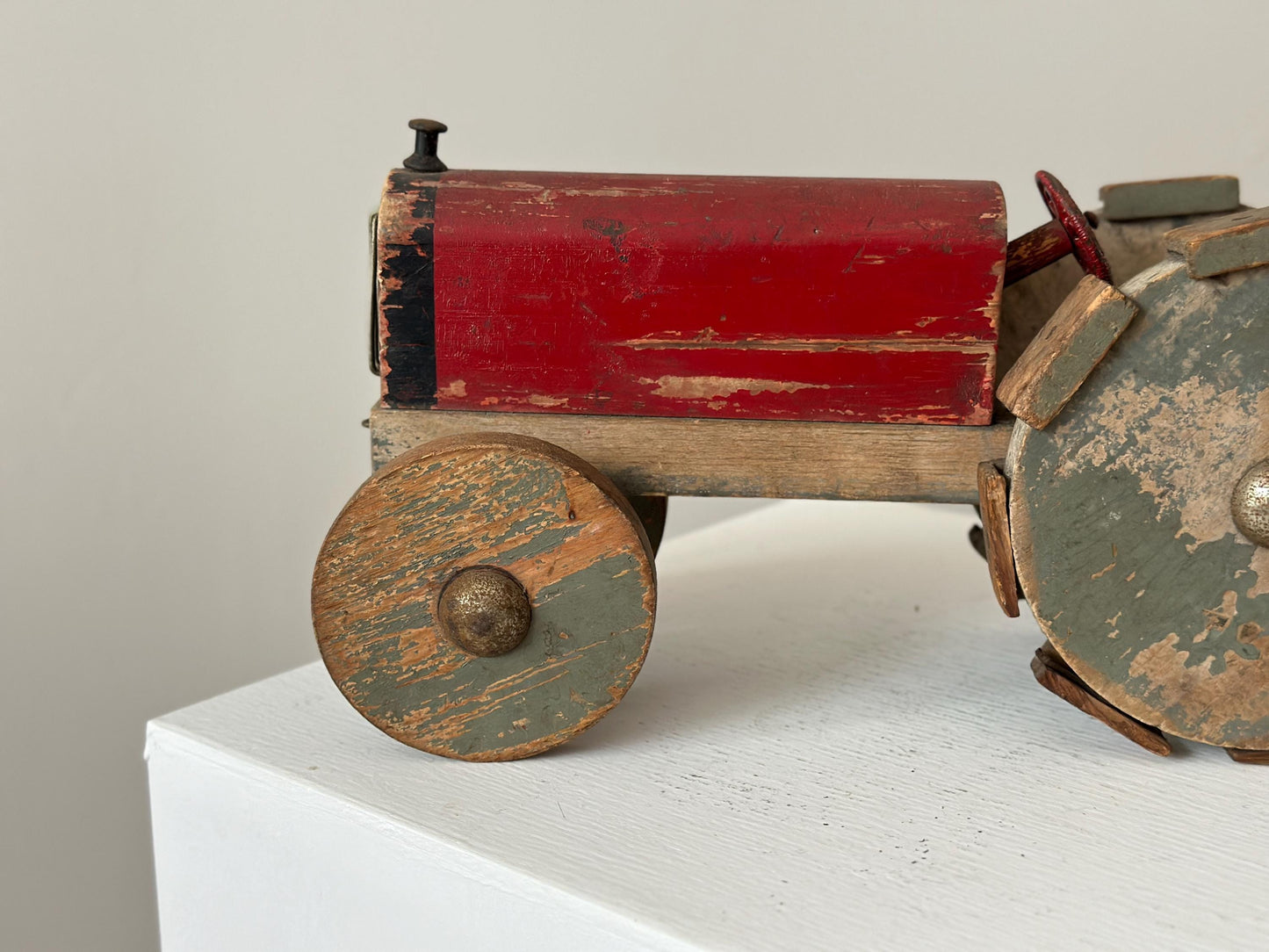 1930s – Primitive folk art toy tractor with red paint and cleated wheels